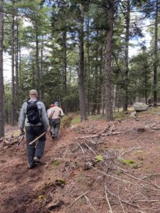 volunteer trail day workers hiking with tools