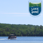 a pontoon boat going across the and the LakeSmart logo in the top right of the image