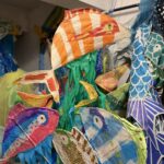 Colorful fish puppets created with paper mache