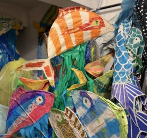 Colorful fish puppets created with paper mache