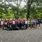 Camp Somerset campers with trash bags full of Japanese Knotweed