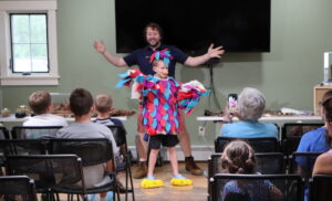 A child dressed up like a bird with their arms out