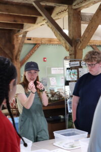 instructor holding an aquatic plant and pointing to it