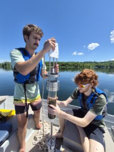 Two Colby College students preparing a sediment sample
