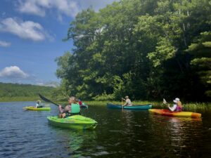 kayakers and a canoe paddling on lower Long Pond