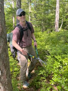 Man holding loppers while doing trail maintenance