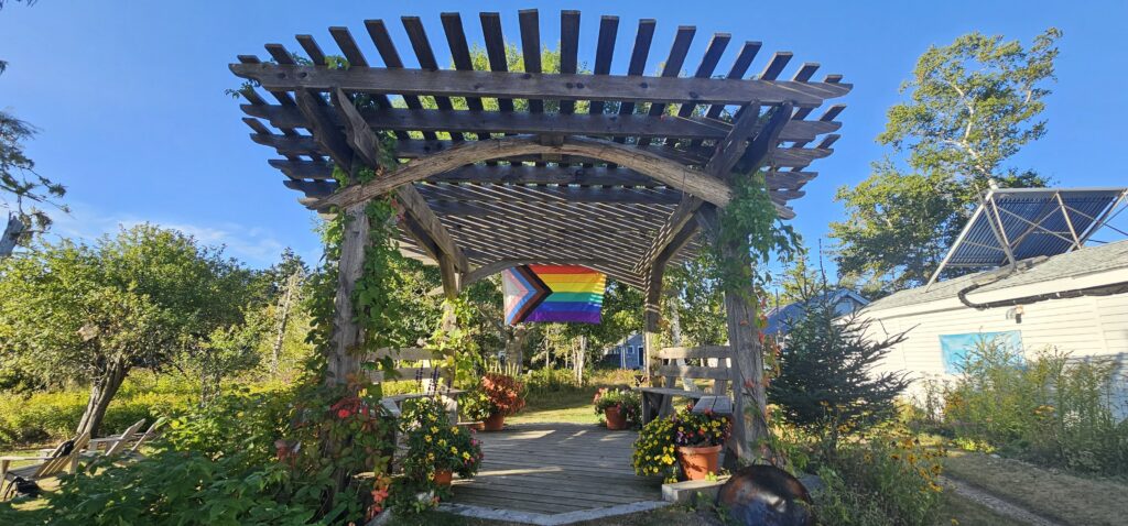 Arbor with Pride Flag hanging from it